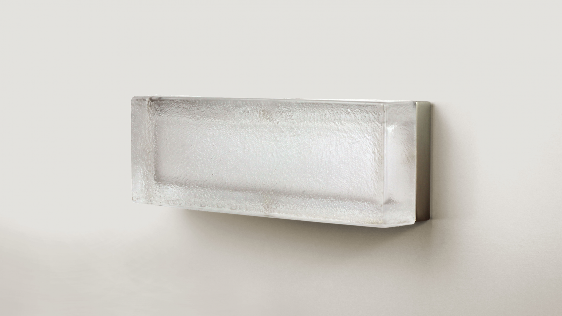 Textured glass luminaire shown wall mounted without the fixture turned on.