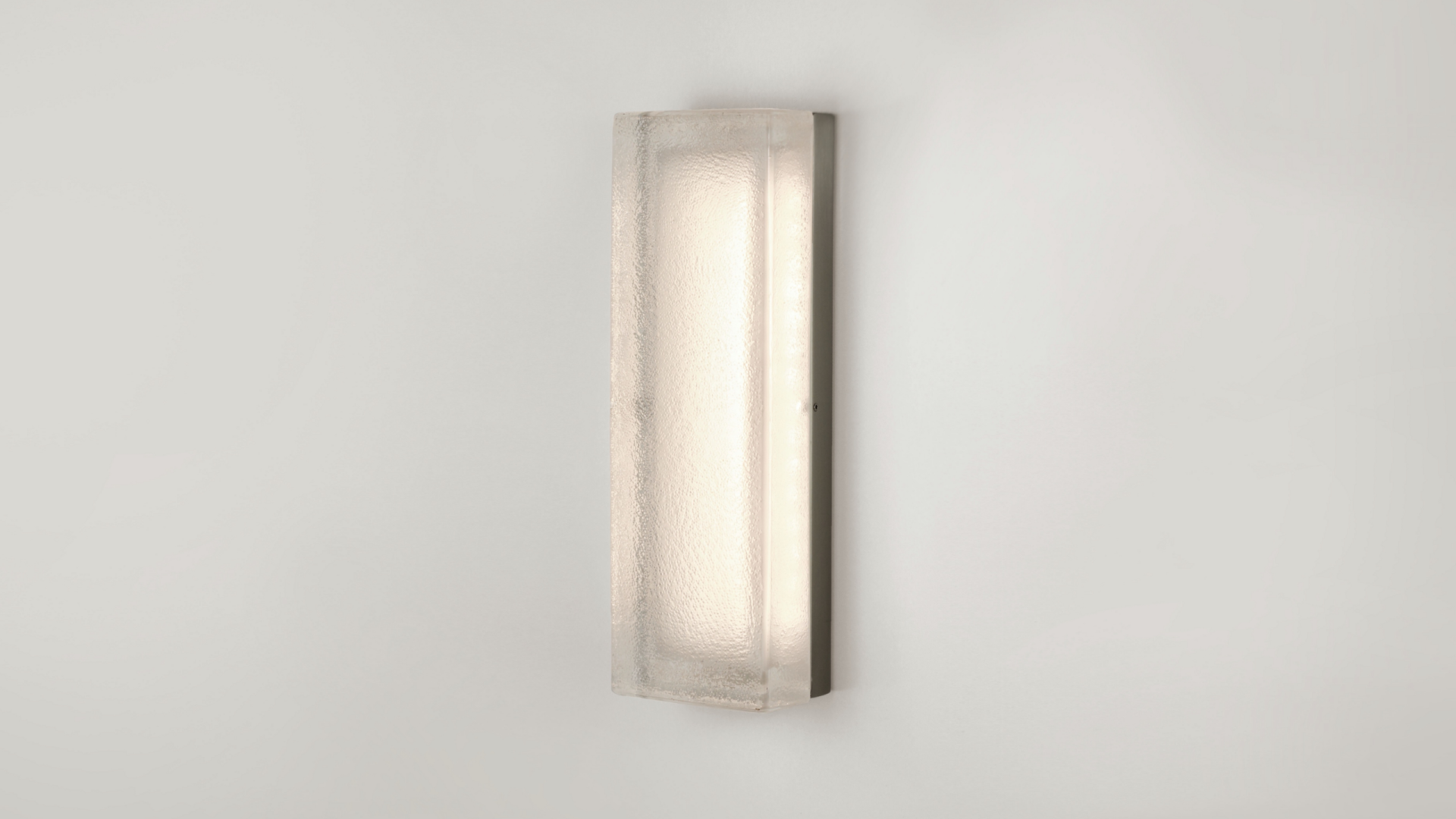 Textured glass luminaire shown wall mounted in a vertical configuration.