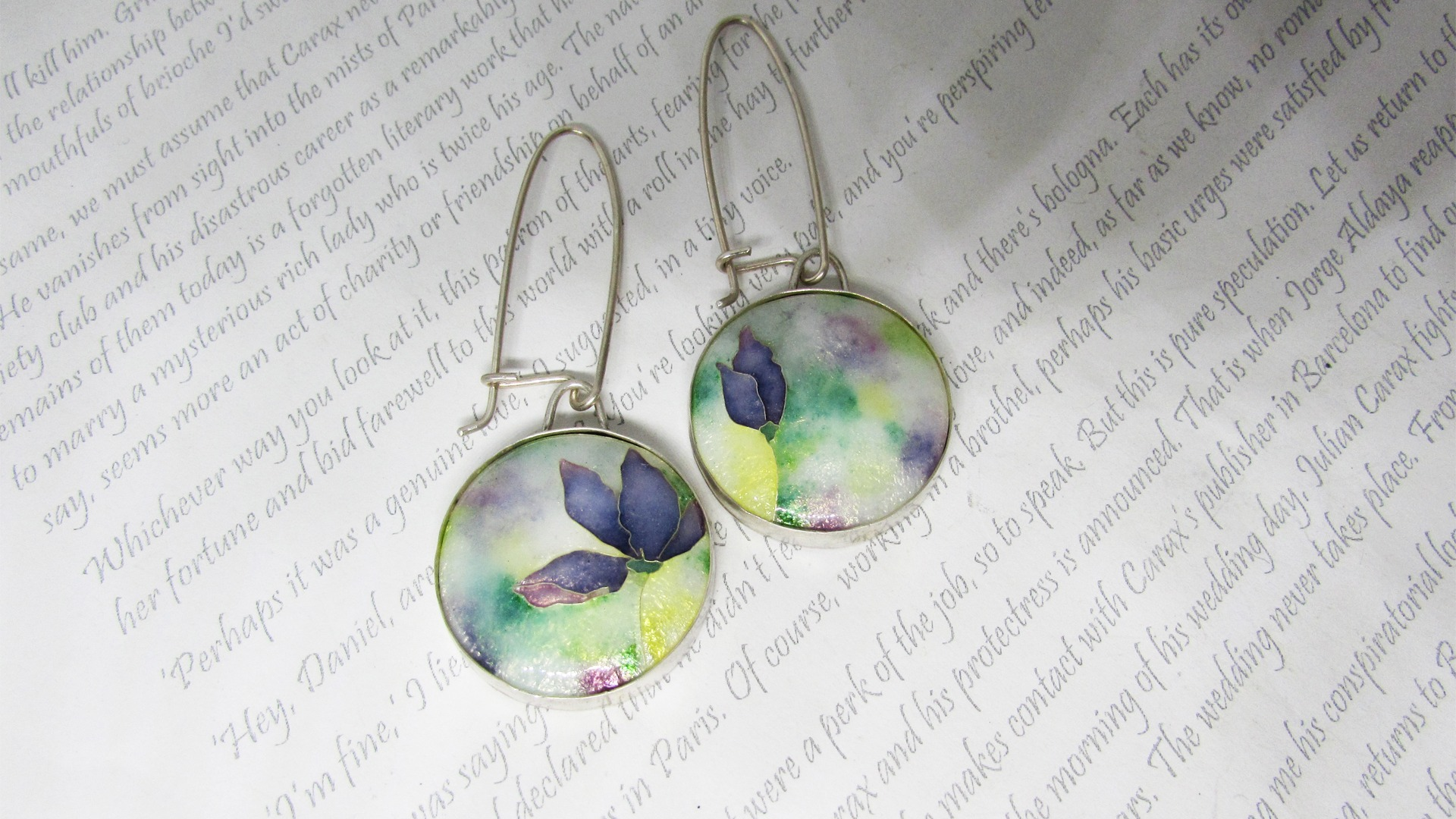 These earrings are made from silver, vitreous enamel and using a technique called cloisonnémade using vitreous enamel and silver. The enamelling technique is called cloisonné