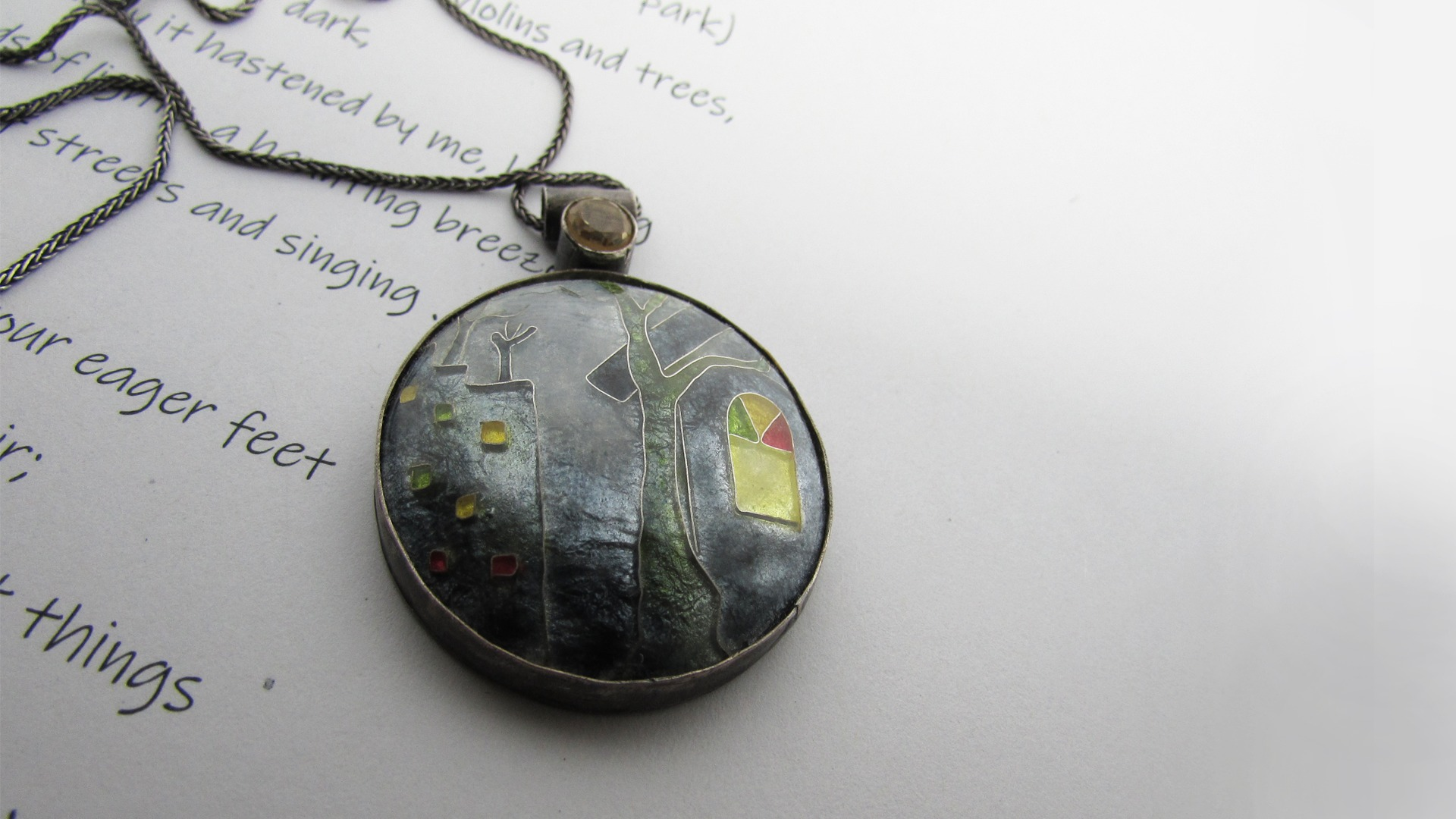 This pendant is made from silver, vitreous enamel and using a technique called cloisonné